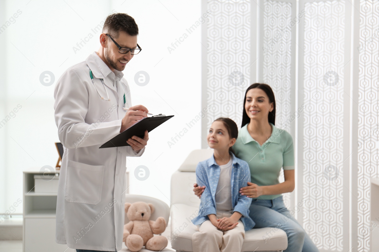 Photo of Mother with daughter visiting pediatrician in hospital