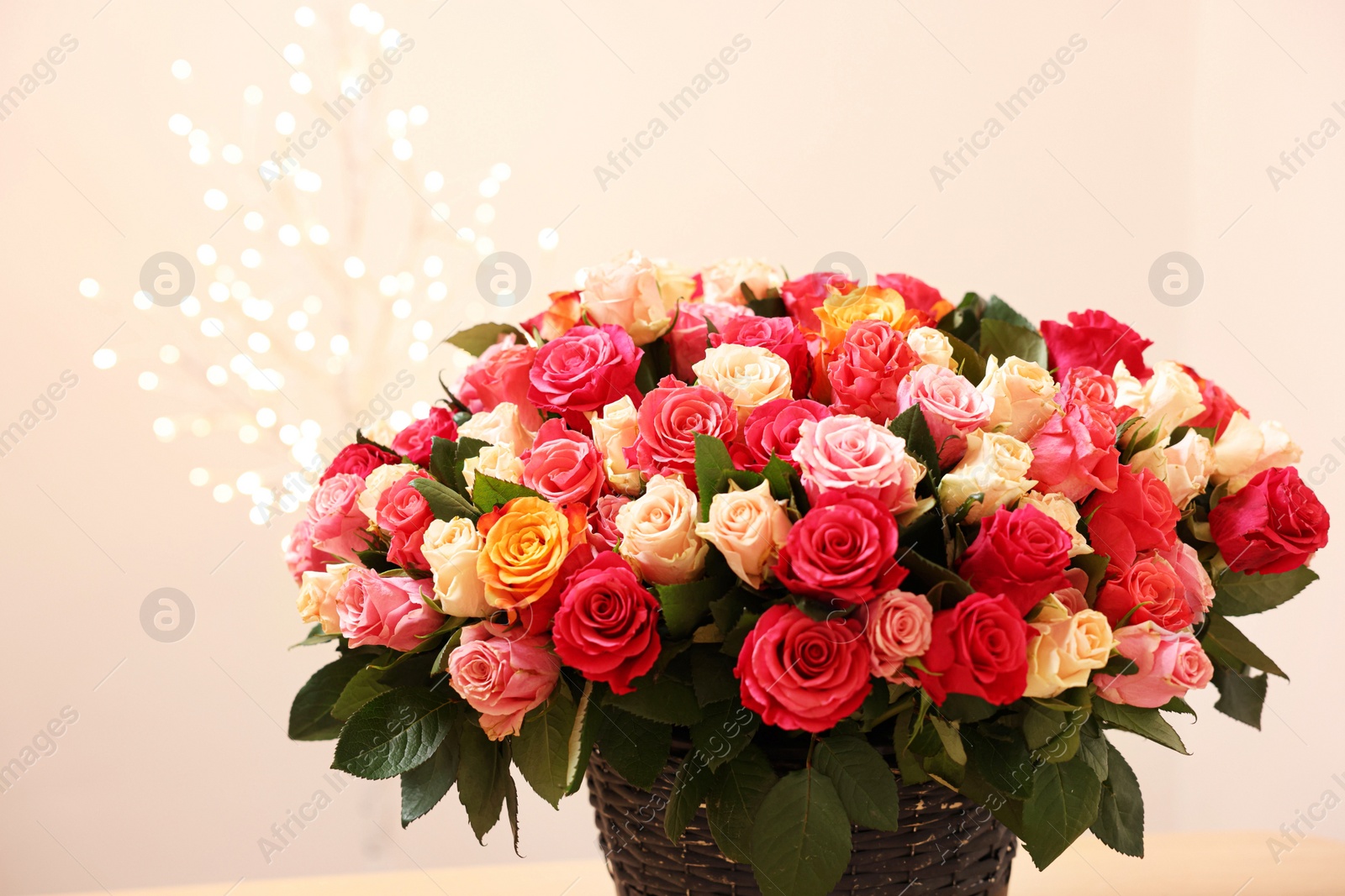 Photo of Beautiful bouquet of colorful roses on beige background