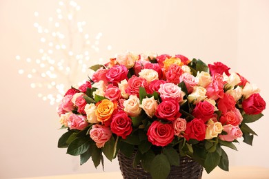 Beautiful bouquet of colorful roses on beige background