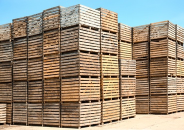 Pile of empty wooden crates outdoors on sunny day