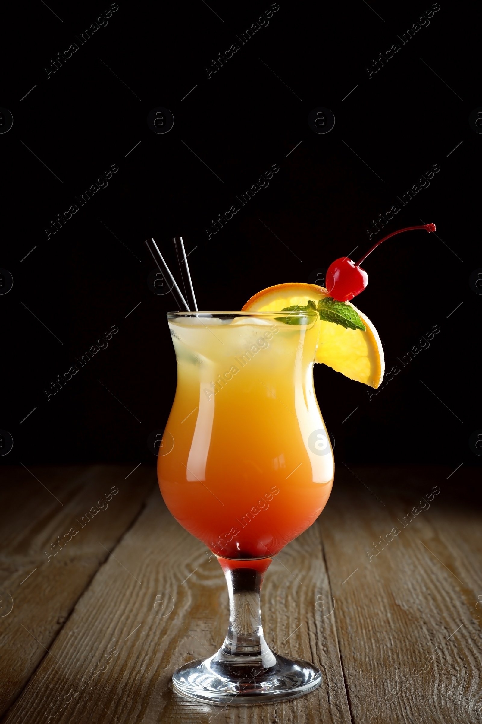 Photo of Just made appetizing cocktail Sex on the Beach, black background