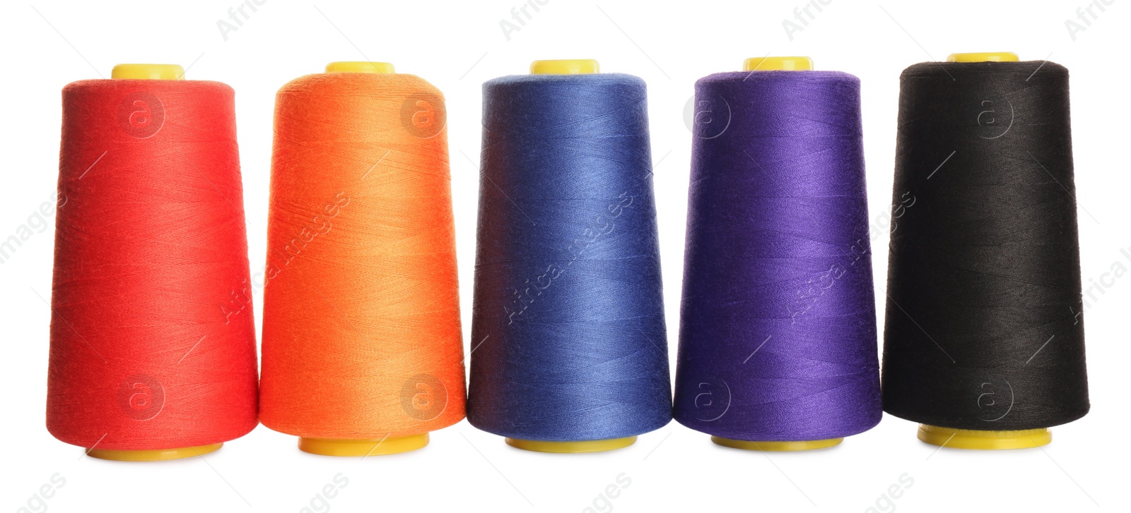 Photo of Set of colorful sewing threads on white background