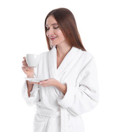 Photo of Young woman in bathrobe with cup of drink on white background