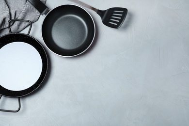 Photo of Flat lay composition with clean cookware and space for text on grey background