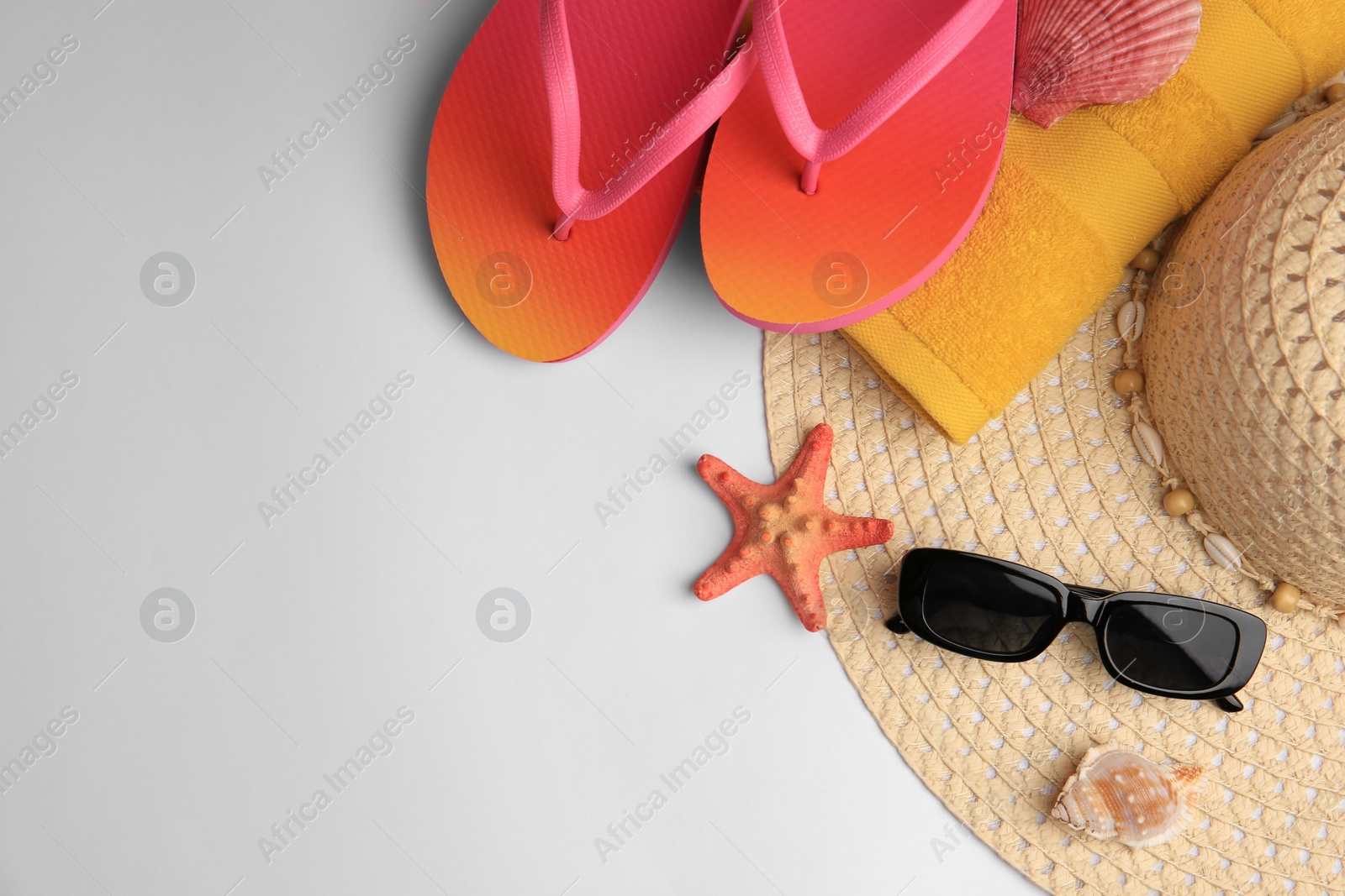 Photo of Flat lay composition with beach accessories on white background, space for text