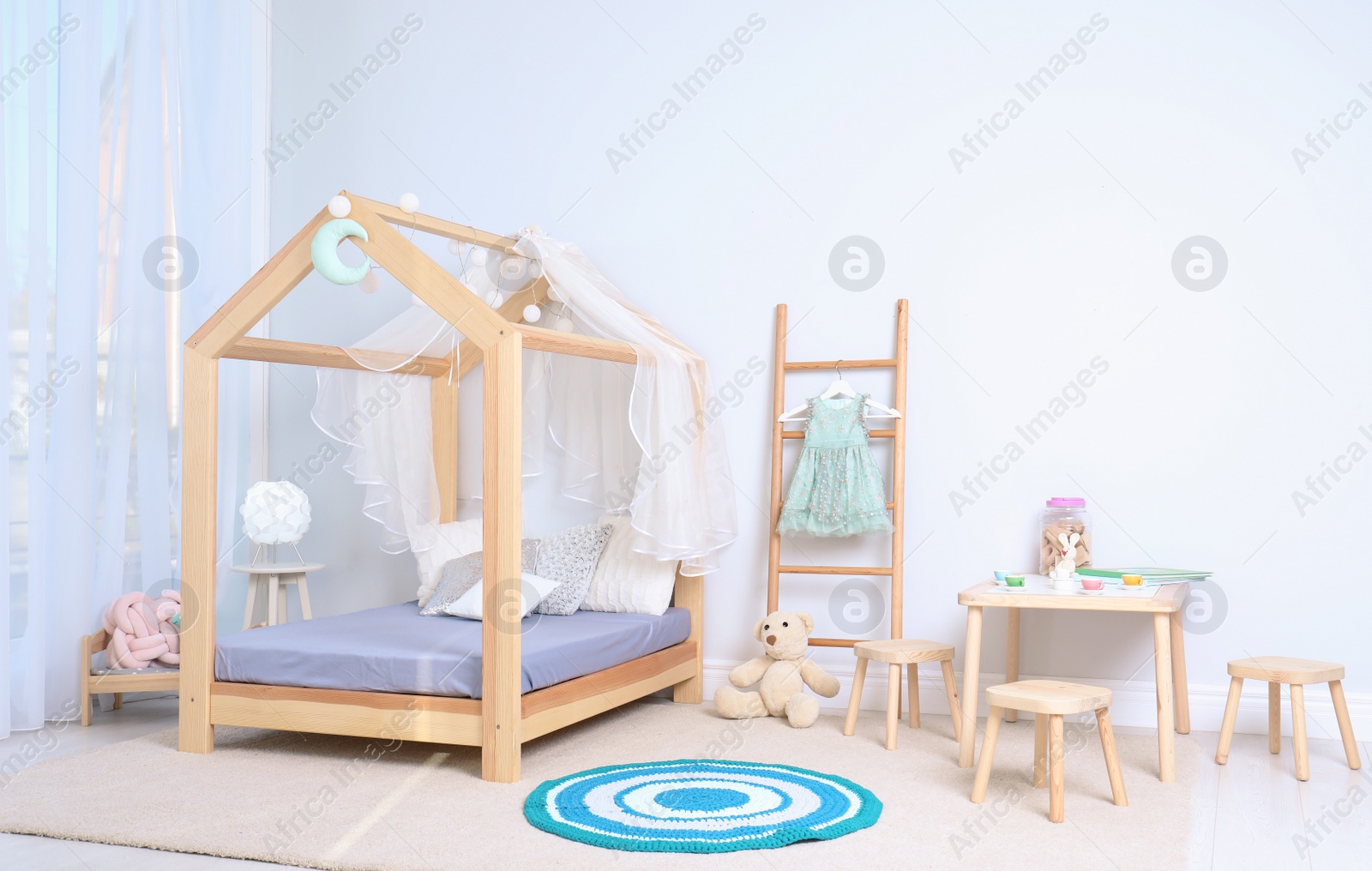 Photo of View of cozy child's room interior with cute bed