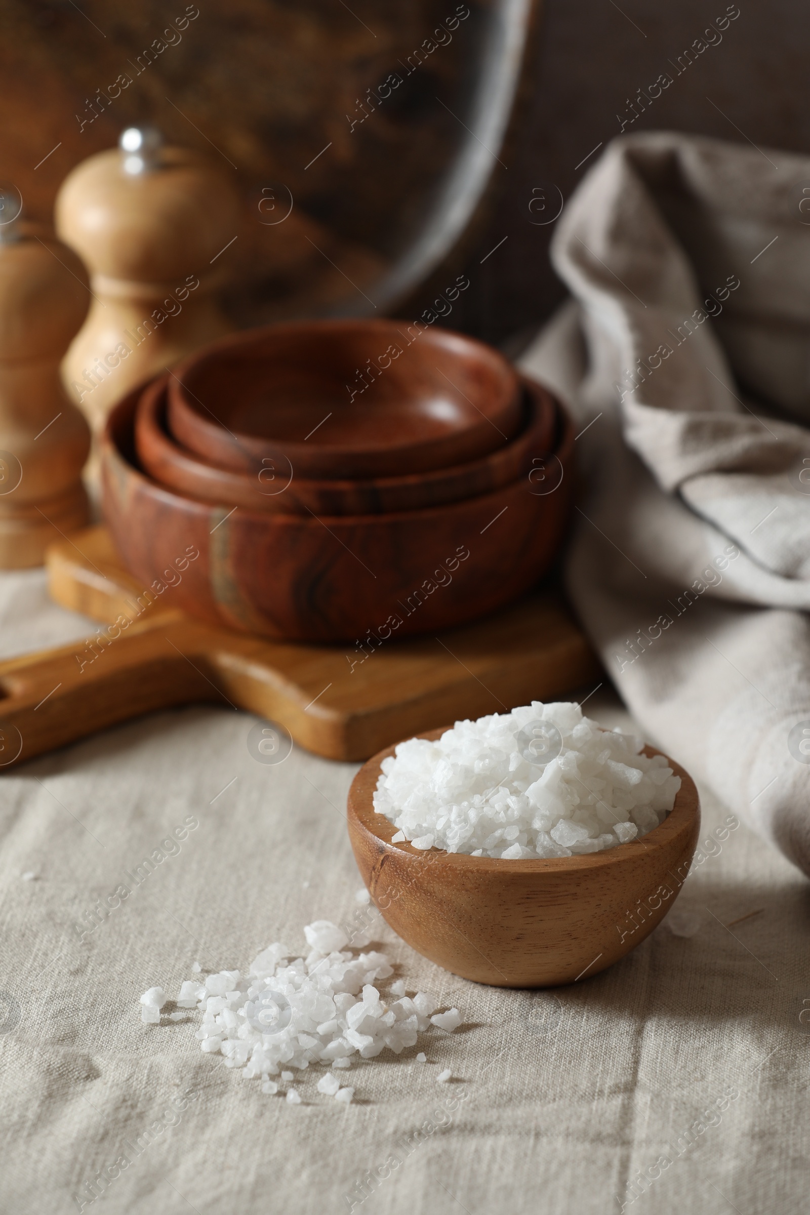 Photo of Organic salt in wooden bowl on table