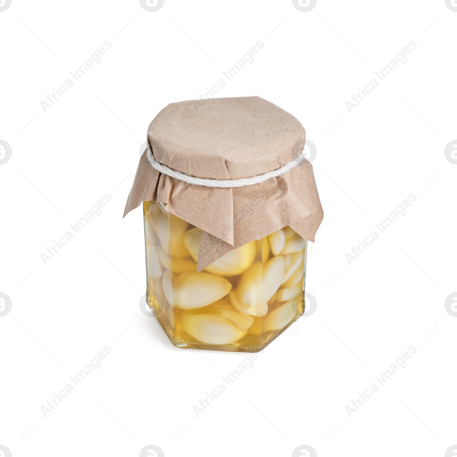 Photo of Garlic with honey in glass jar isolated on white