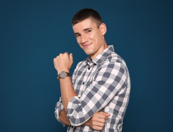 Photo of Portrait of handsome young man on blue background