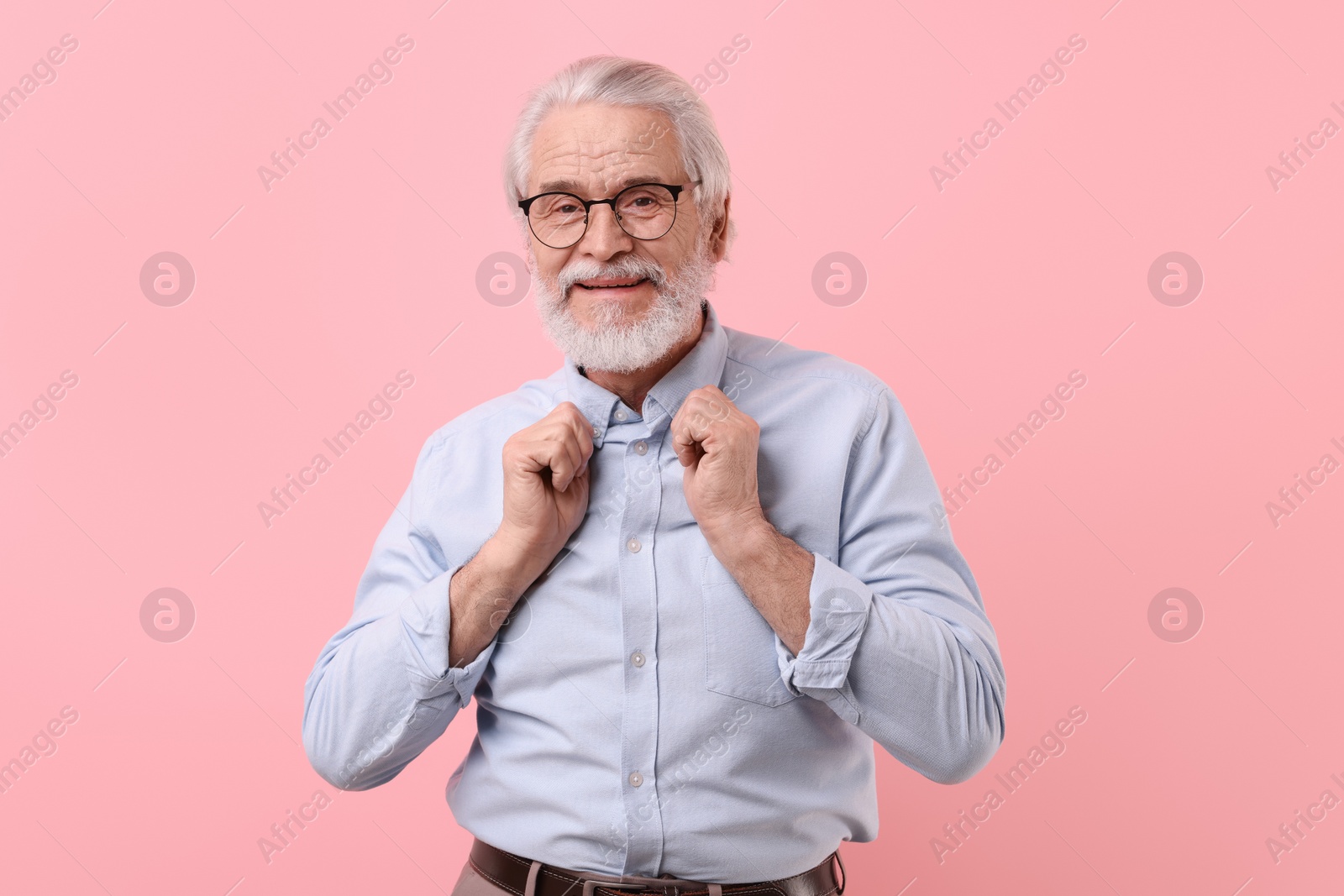 Photo of Portrait of stylish grandpa with glasses on pink background