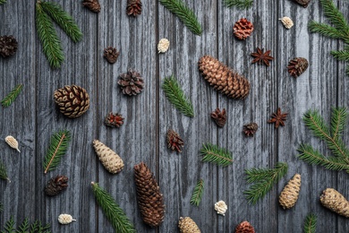 Photo of Flat lay composition with pinecones on black wooden background