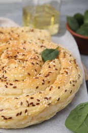 Photo of Delicious puff pastry with spinach on table, closeup