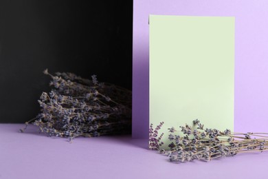 Photo of Scented sachet and dried lavender on color background