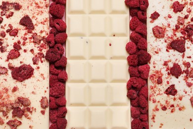 White chocolate bars with freeze dried fruits as background, closeup