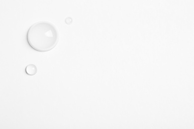 Water drops on white background, top view. Space for text