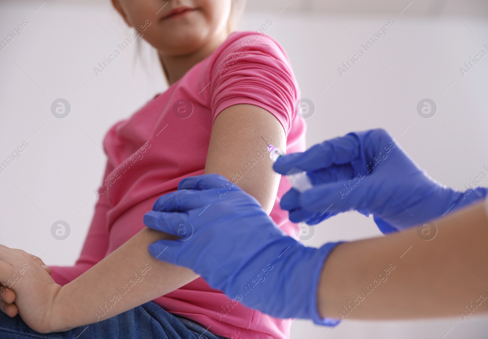 Photo of Little girl receiving chickenpox vaccination in clinic, closeup. Varicella virus prevention