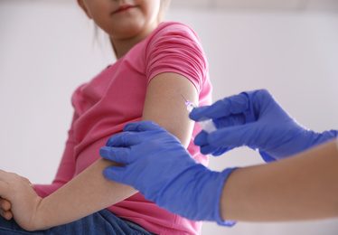 Little girl receiving chickenpox vaccination in clinic, closeup. Varicella virus prevention