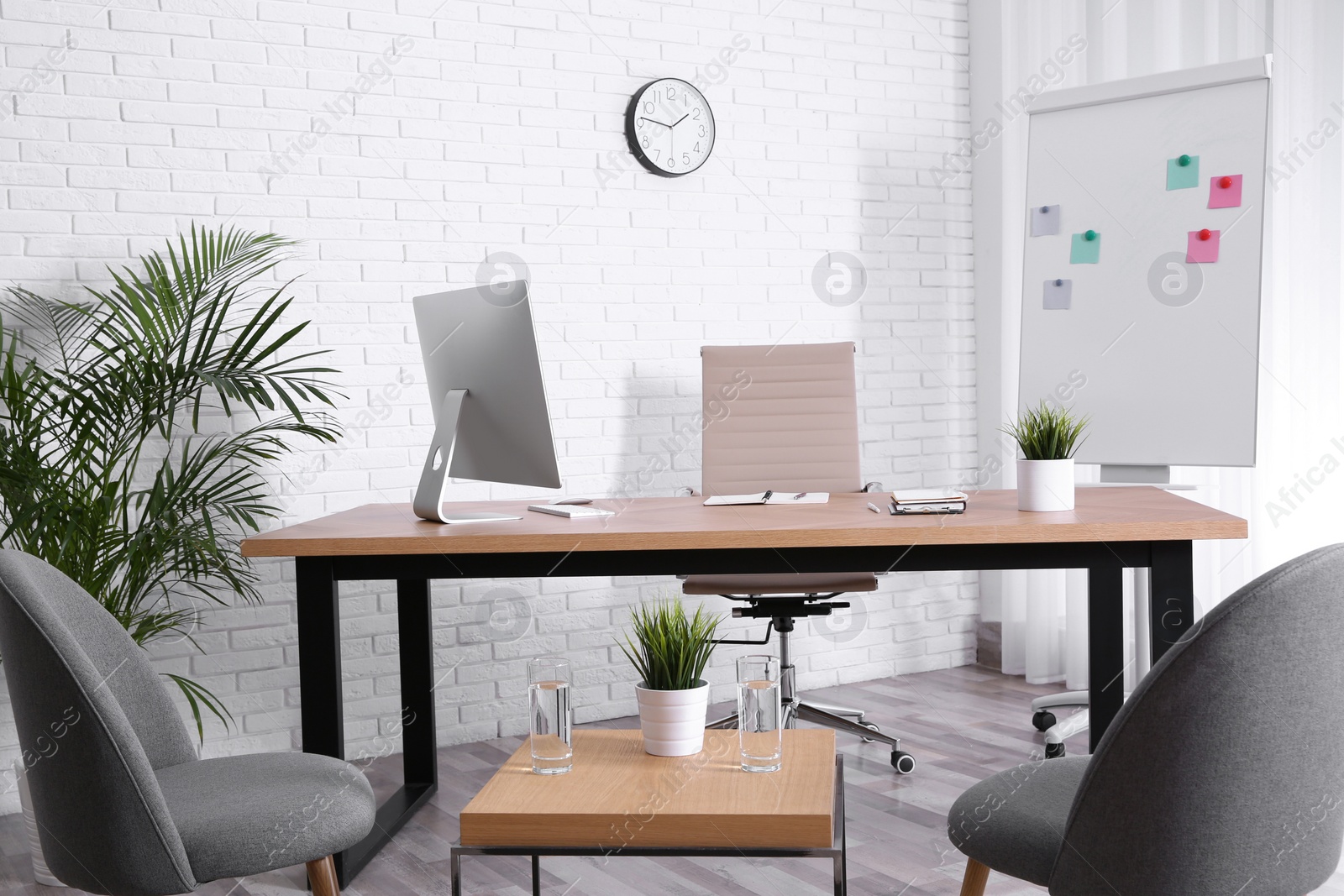 Photo of Interior of modern office with table, chairs and computer