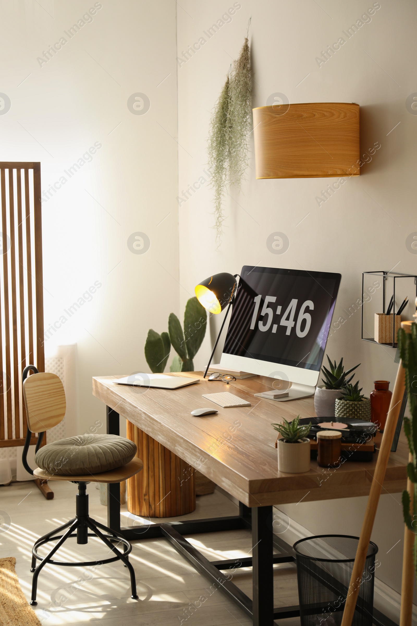 Photo of Room interior with comfortable workplace. Modern computer on wooden desk