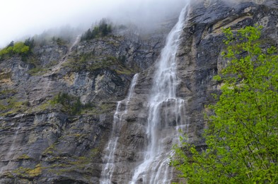 Photo of Low angle view of beautiful waterfall in mountains