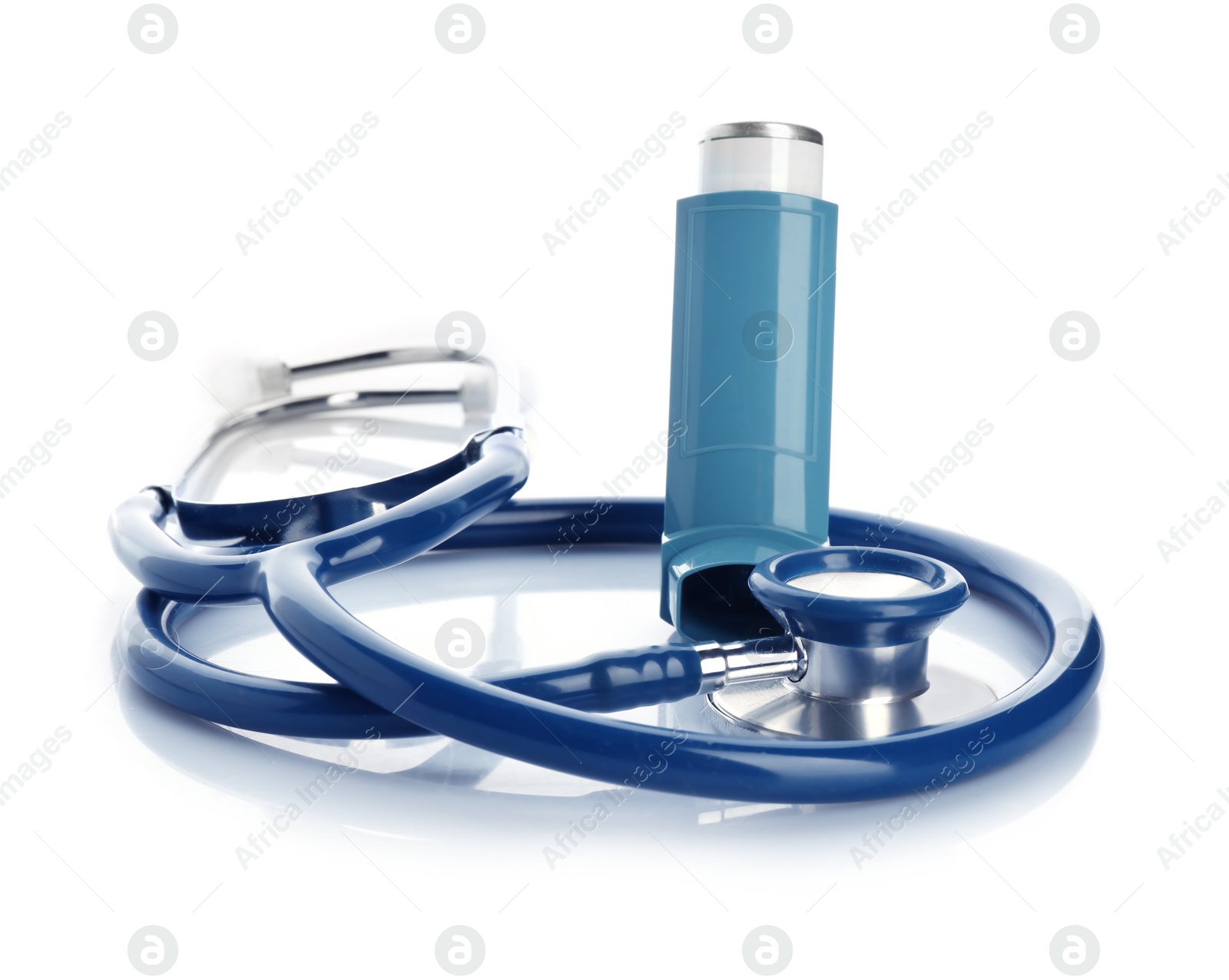 Photo of Asthma inhaler and stethoscope on white background