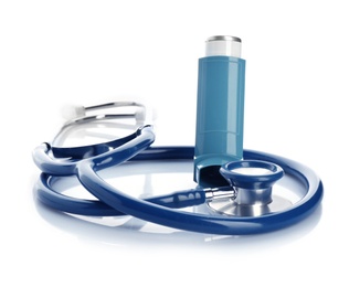 Photo of Asthma inhaler and stethoscope on white background