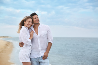 Happy couple on beach, space for text. Romantic walk