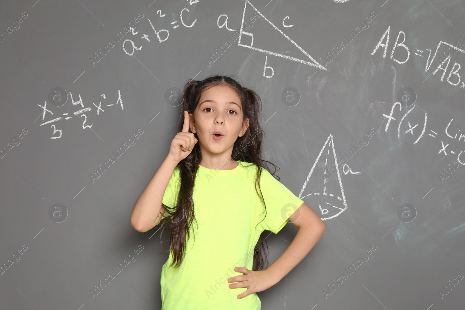 Photo of Little school child and mathematical formulas on grey background