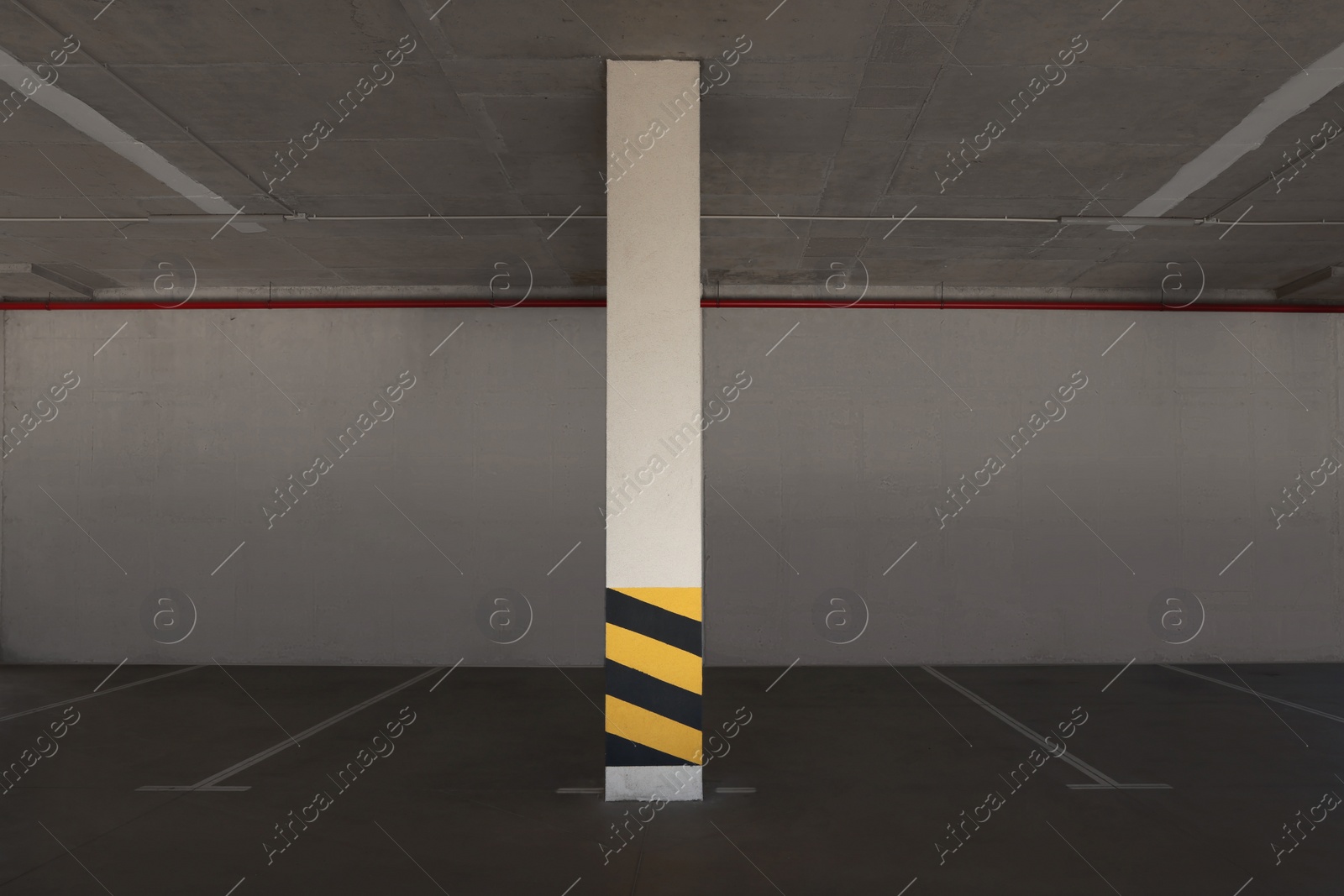 Photo of Empty car parking garage with warning stripes on column