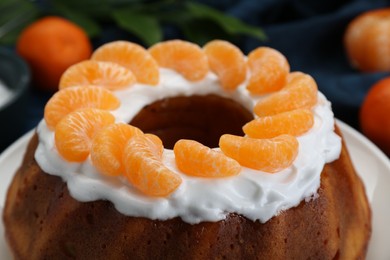 Photo of Homemade yogurt cake with tangerines and cream, closeup