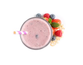 Photo of Glass of tasty smoothie with berries, mint and oatmeal on white background, top view