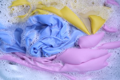 Photo of Color clothing in suds, top view. Hand washing laundry