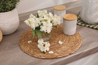 Photo of Beautiful jasmine flowers on wooden table indoors