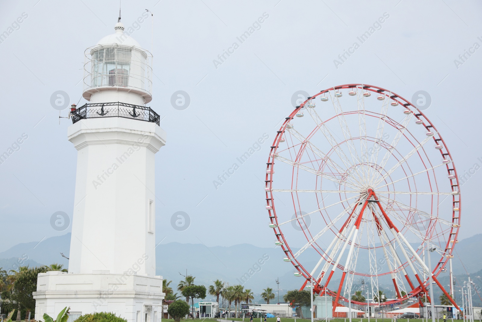 Photo of BATUMI, GEORGIA - MAY 31, 2022: Beautiful street with lighthouse and Ferris wheel