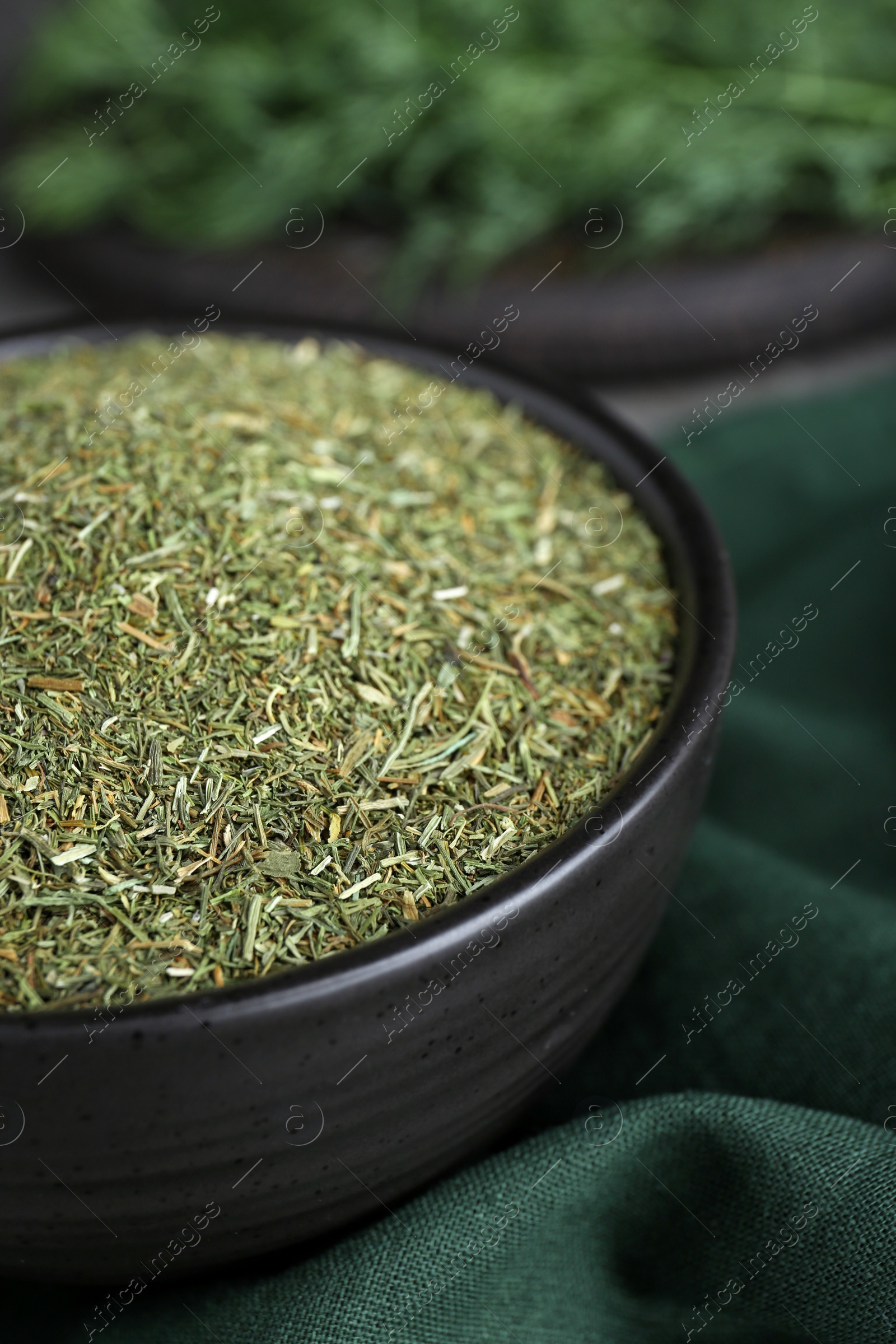 Photo of Bowl with dried dill on table, closeup
