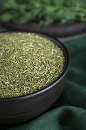 Bowl with dried dill on table, closeup