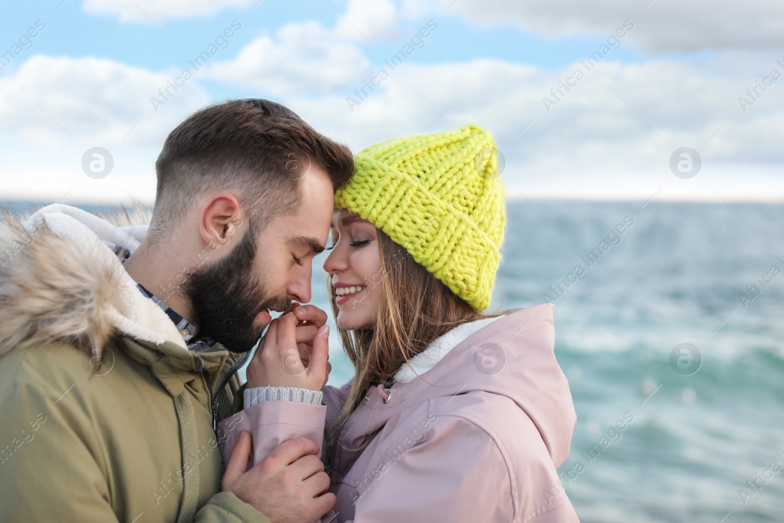 Photo of Lovely young couple near sea. Space for text
