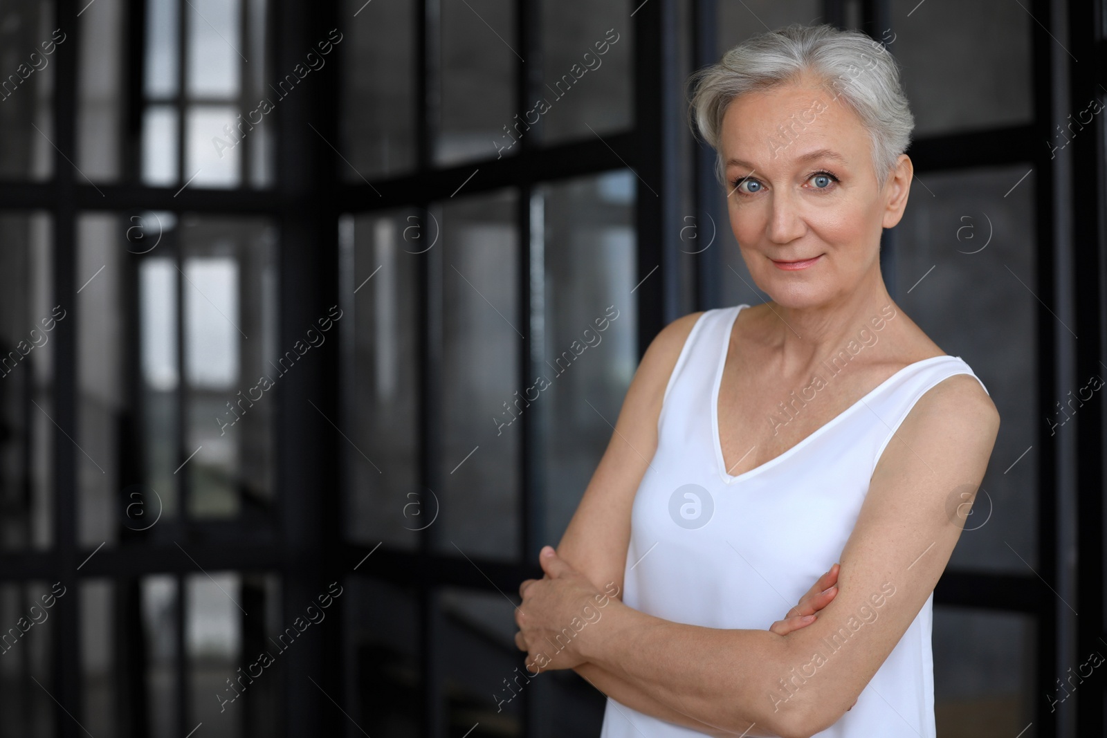 Photo of Portrait of happy mature woman indoors, space for text. Smart aging