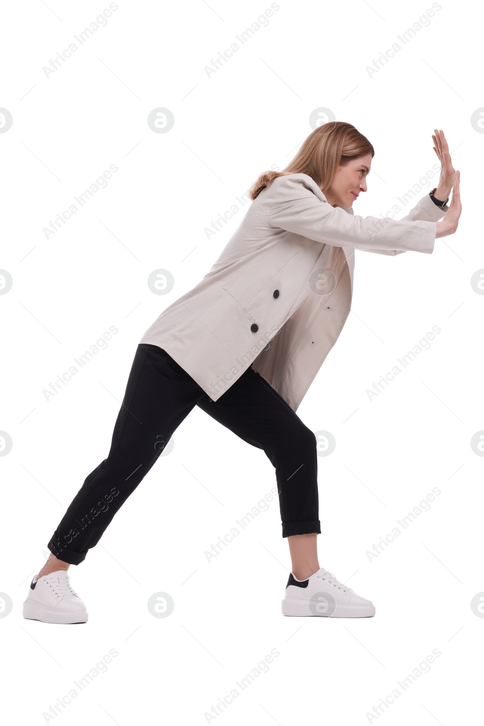 Photo of Beautiful businesswoman pushing something on white background