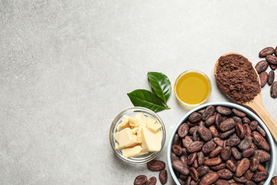 Flat lay composition with organic cocoa butter on light grey table. Space for text