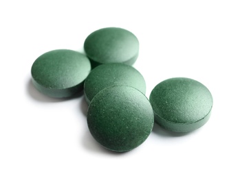 Spirulina tablets on white background. Healthy lifestyle