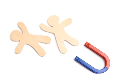 Photo of Red and blue horseshoe magnet with wooden people figures on white background, top view