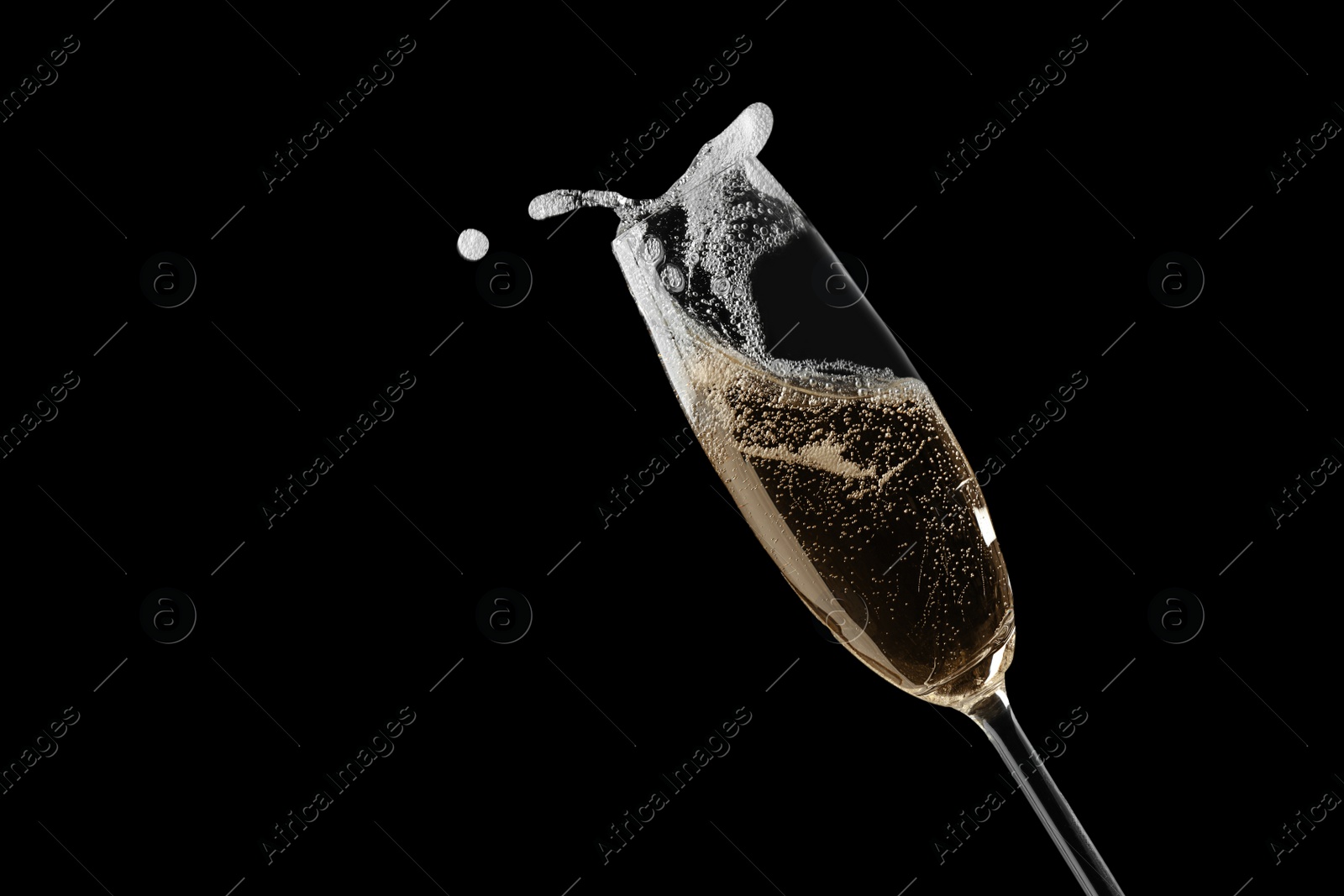 Photo of Glass of fizzy champagne on black background, closeup. Space for text