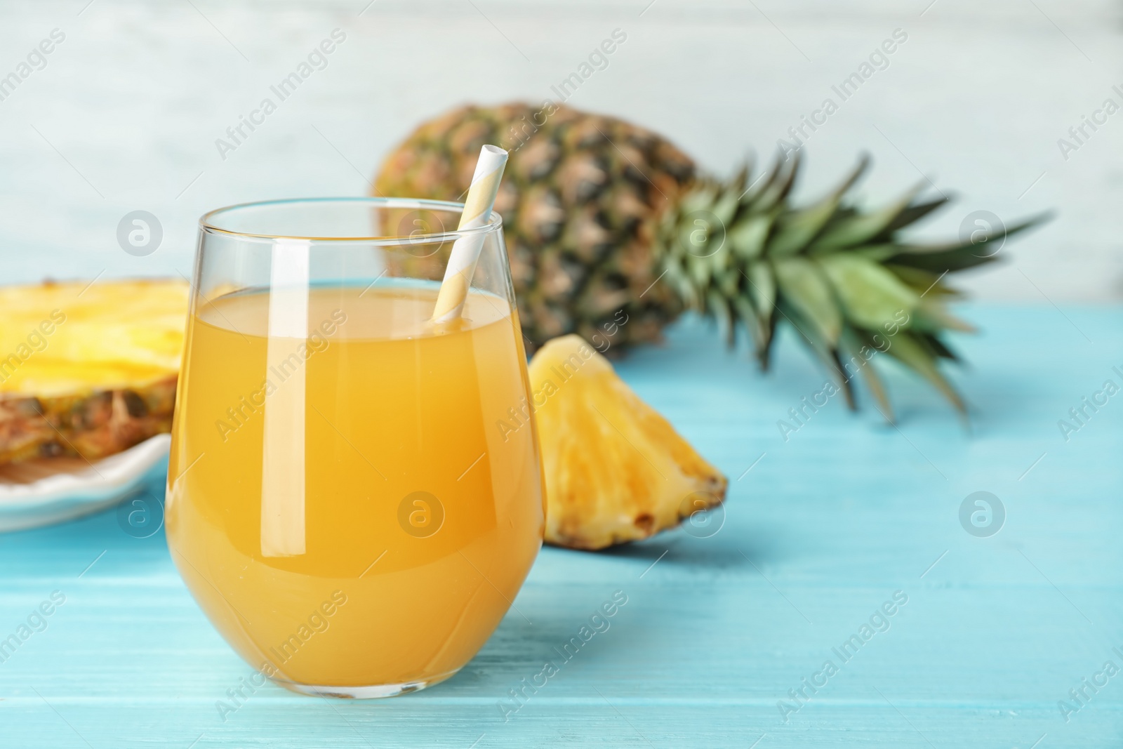 Photo of Glass with delicious pineapple juice on table