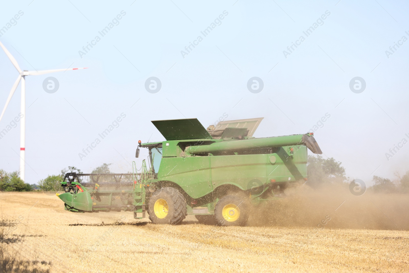 Photo of Modern combine harvester working in agricultural field