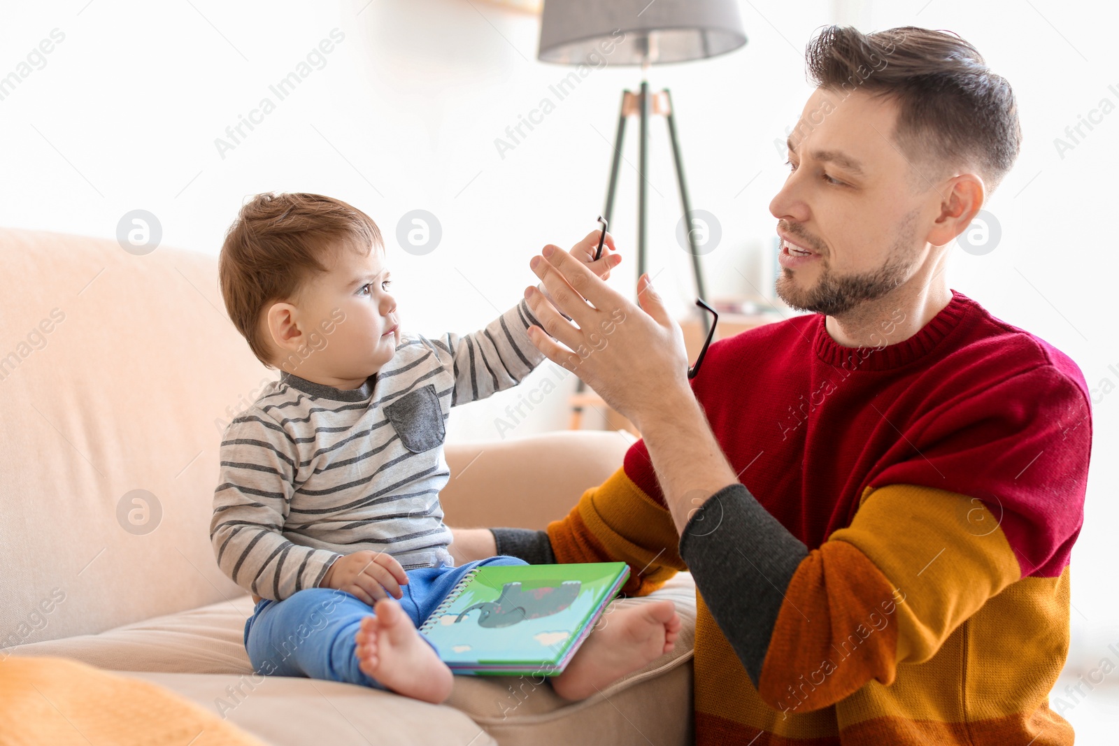 Photo of Dad spending time with his son at home