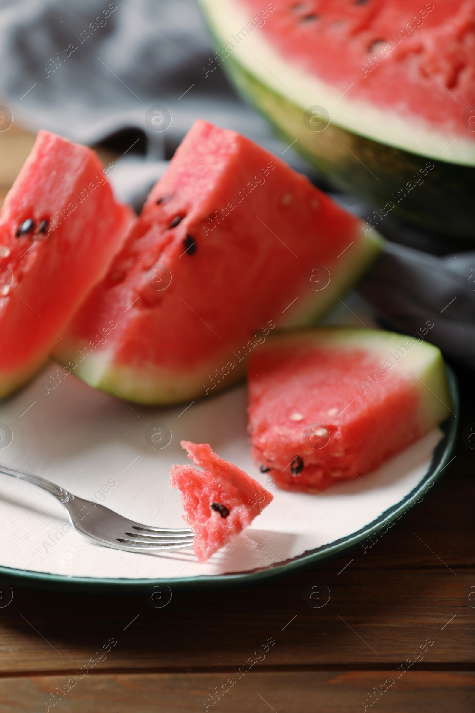 Photo of Sliced fresh juicy watermelon on wooden table, closeup