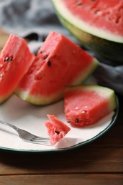 Photo of Sliced fresh juicy watermelon on wooden table, closeup