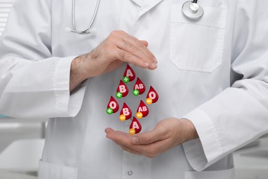 Image of Images of drops representing different blood types and doctor, closeup