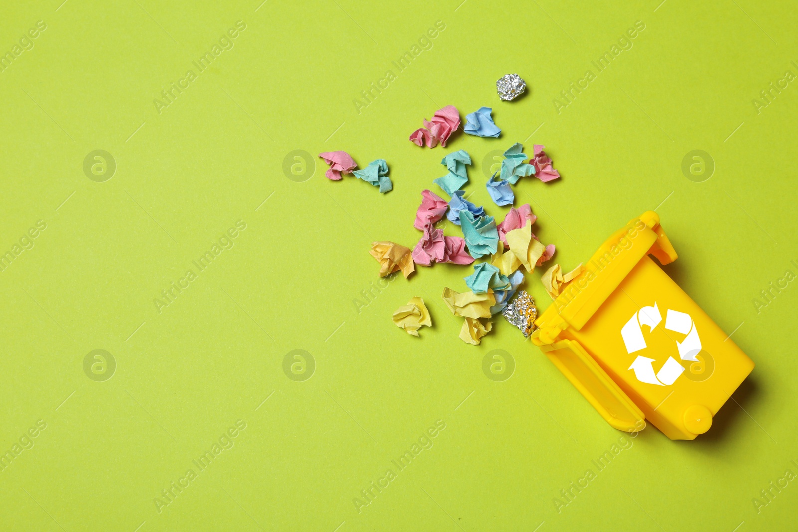 Photo of Trash bin and different garbage on color background, top view with space for text. Waste recycling concept